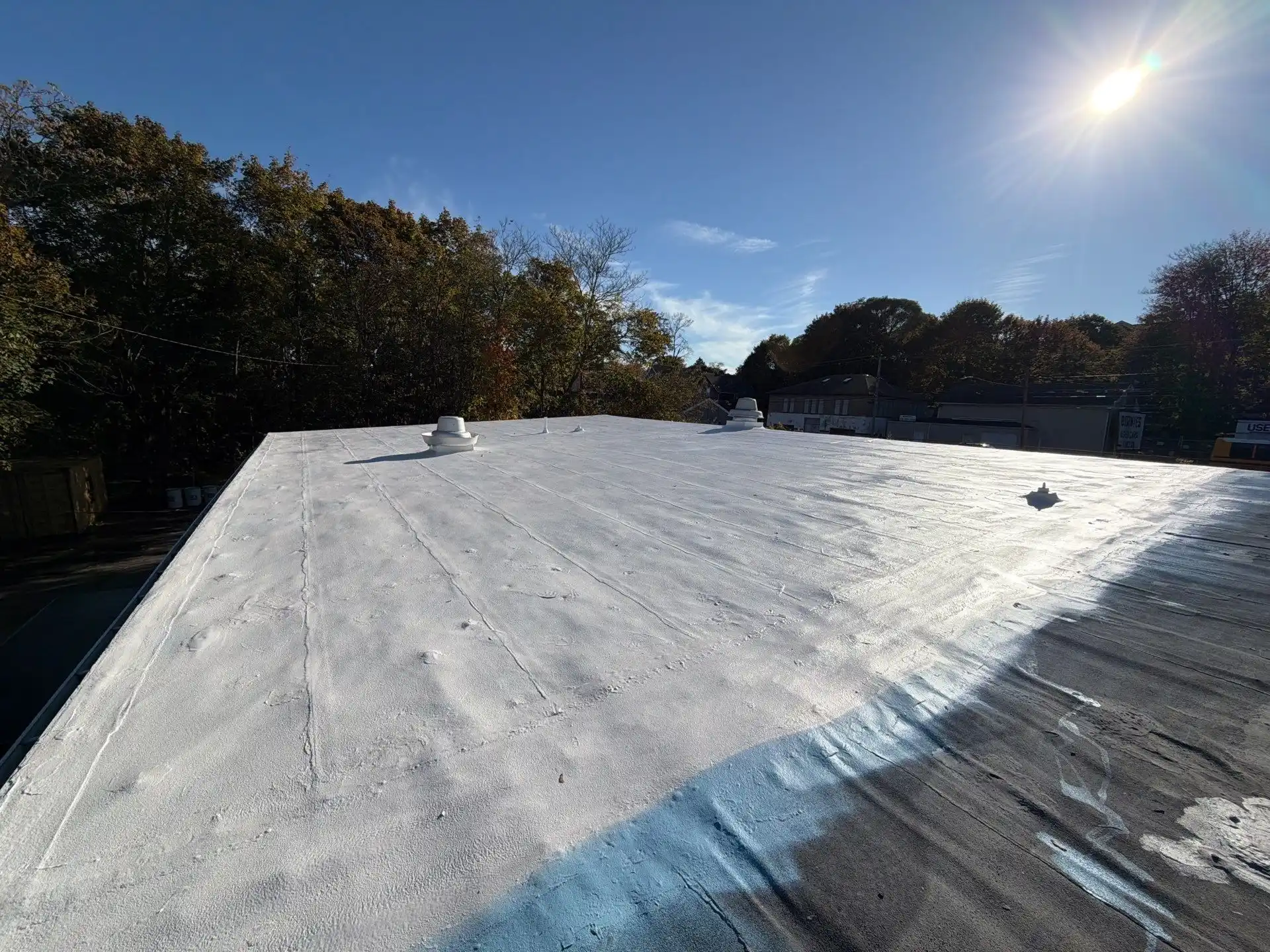 Coated commercial roof providing additional weather protection